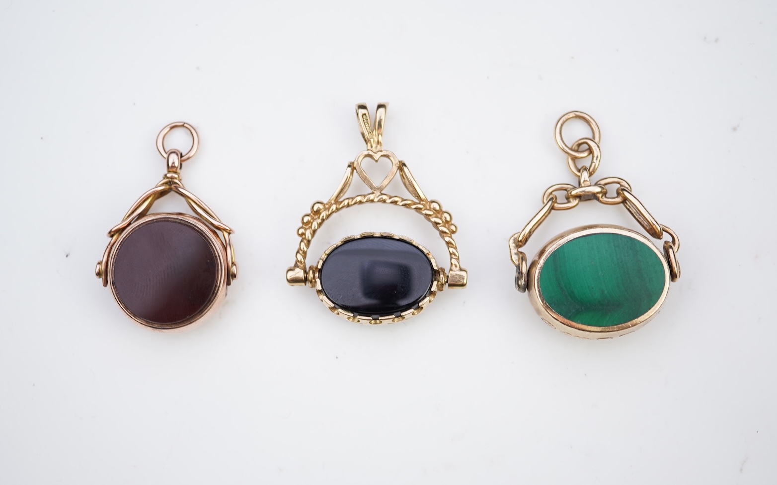 Three 9ct gold fob pendants